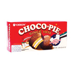 Orion Chocopie snack with marshmallow filling and chocolate coating, displayed on a plate with some pieces cut open.