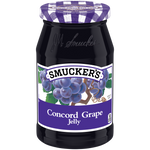 Jar of Smucker's grape jam with a label showing fresh grapes and the brand logo, ready for spreading on bread.