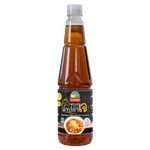 Nguan Chiang Gourmet vegetarian fish sauce made with Himalayan salt, displayed in a clear glass bottle on a grocery shelf.