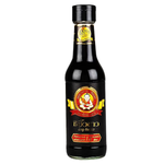 Deksomboon Premium Soy Sauce bottle, soy sauce for cooking and dipping, featuring clear label and dark liquid inside a glass bottle.
