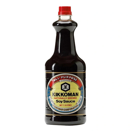 KIKKOMAN soy sauce bottle, 1.6 liters, with clear label and dark liquid inside, on a kitchen countertop.