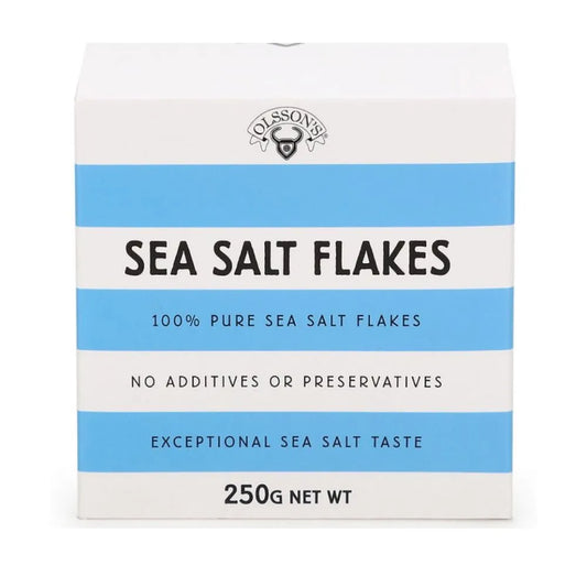 OLSSON Sea Salt Flakes Cube 250G, close-up of flaky sea salt in a clear cube-shaped container, highlighting its texture and natural appearance.